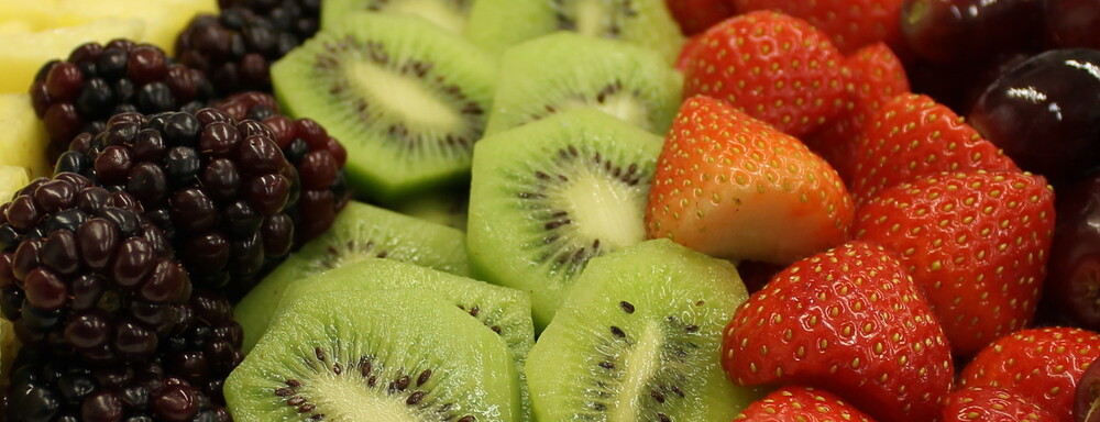 Close-up of fresh fruit, including strawberries and melons