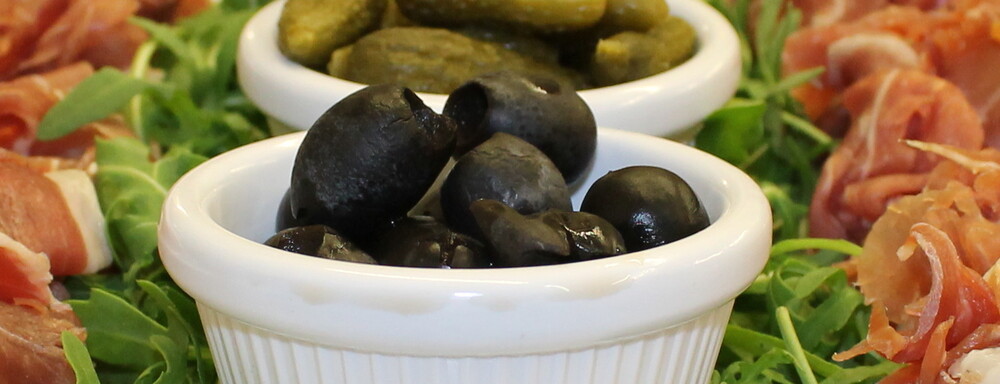 Various buffet salads in white bowls